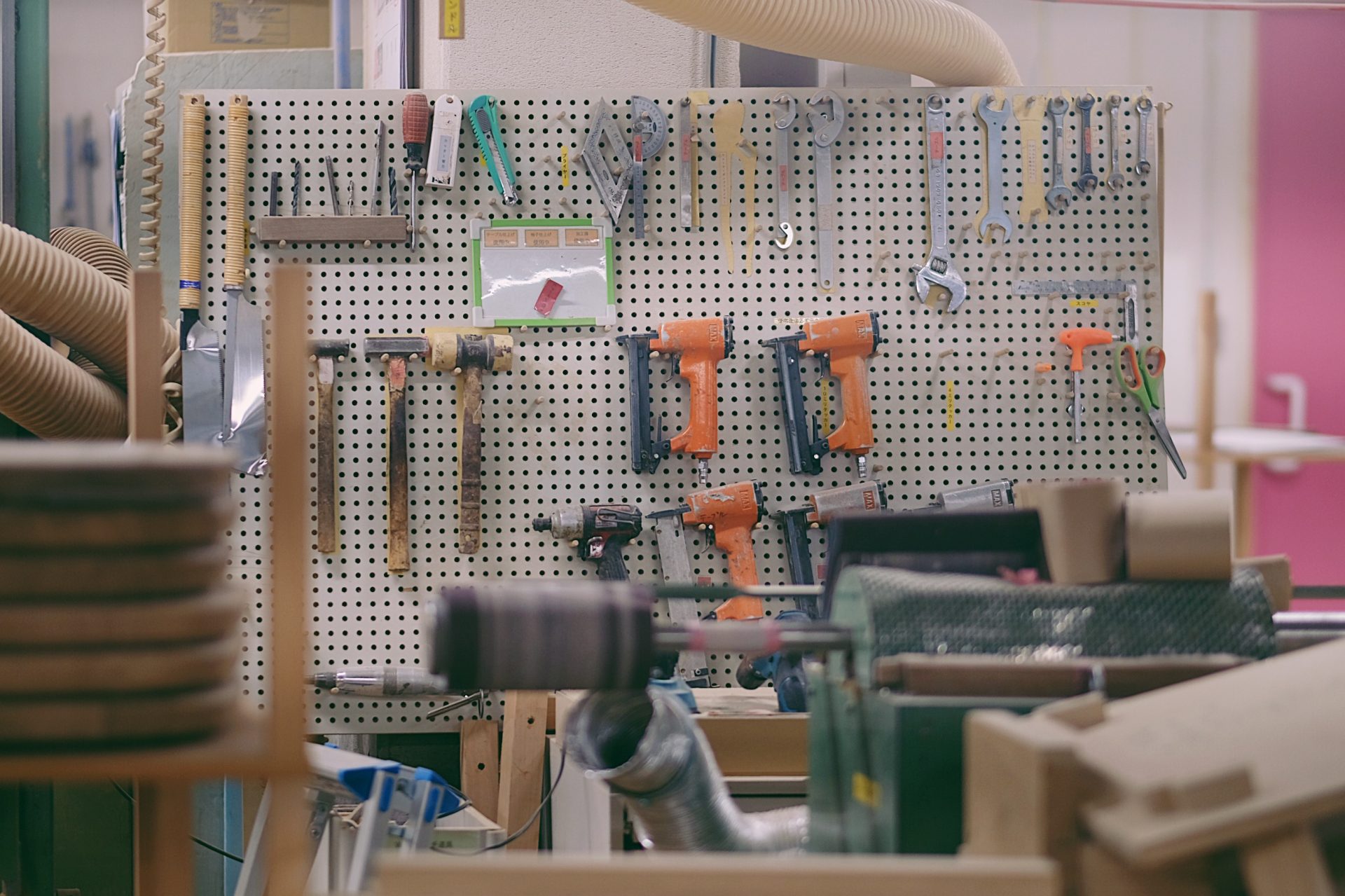 A tool shelf of our factory. Saws, hammers, wrenches, etc. are hanged.