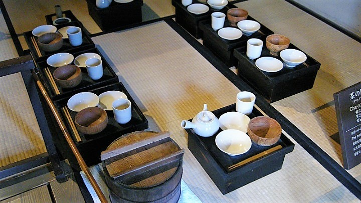 Another image of Japanese traditional meal. A small table for each person. Three bowls and a cup on it.