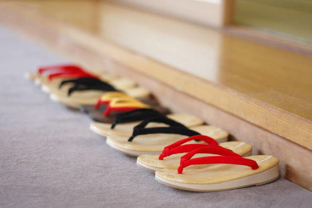 In the entrance of a Japanese house, there are some zo-ri (Japanese traditional shoes) are aligned.