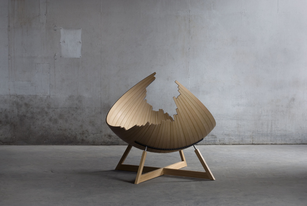 A strange-shape wooden lounge chair. It consists of multiple boards and changes its shape flexibly.