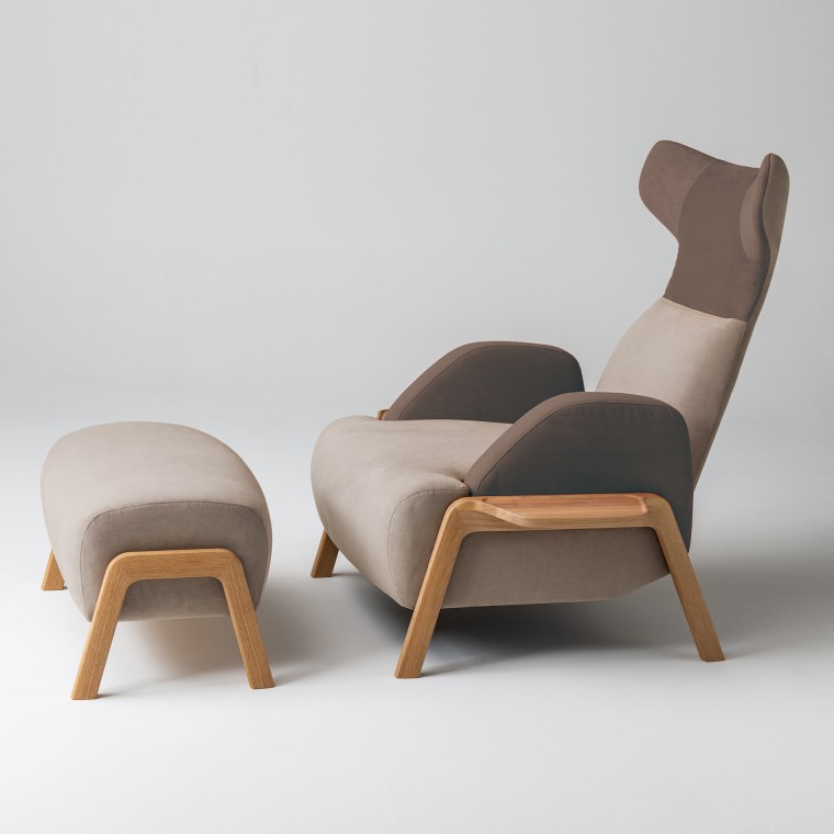 A set of a lounge chair and ottoman, upholstered with Ultrasuede fabric, beige in color.