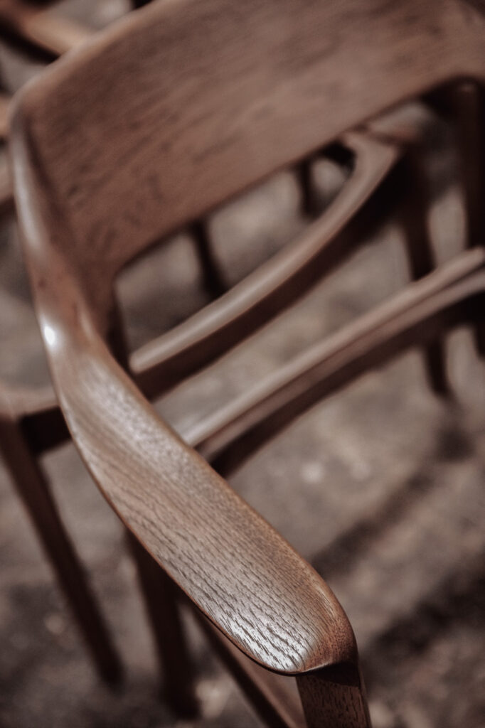 A wood frame of a dining chair. It's in dark color.