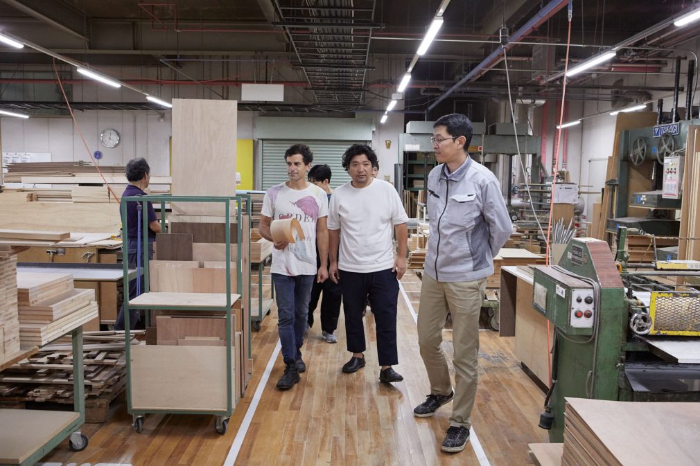 Our factory staff and two designers are walking together through machine tools.