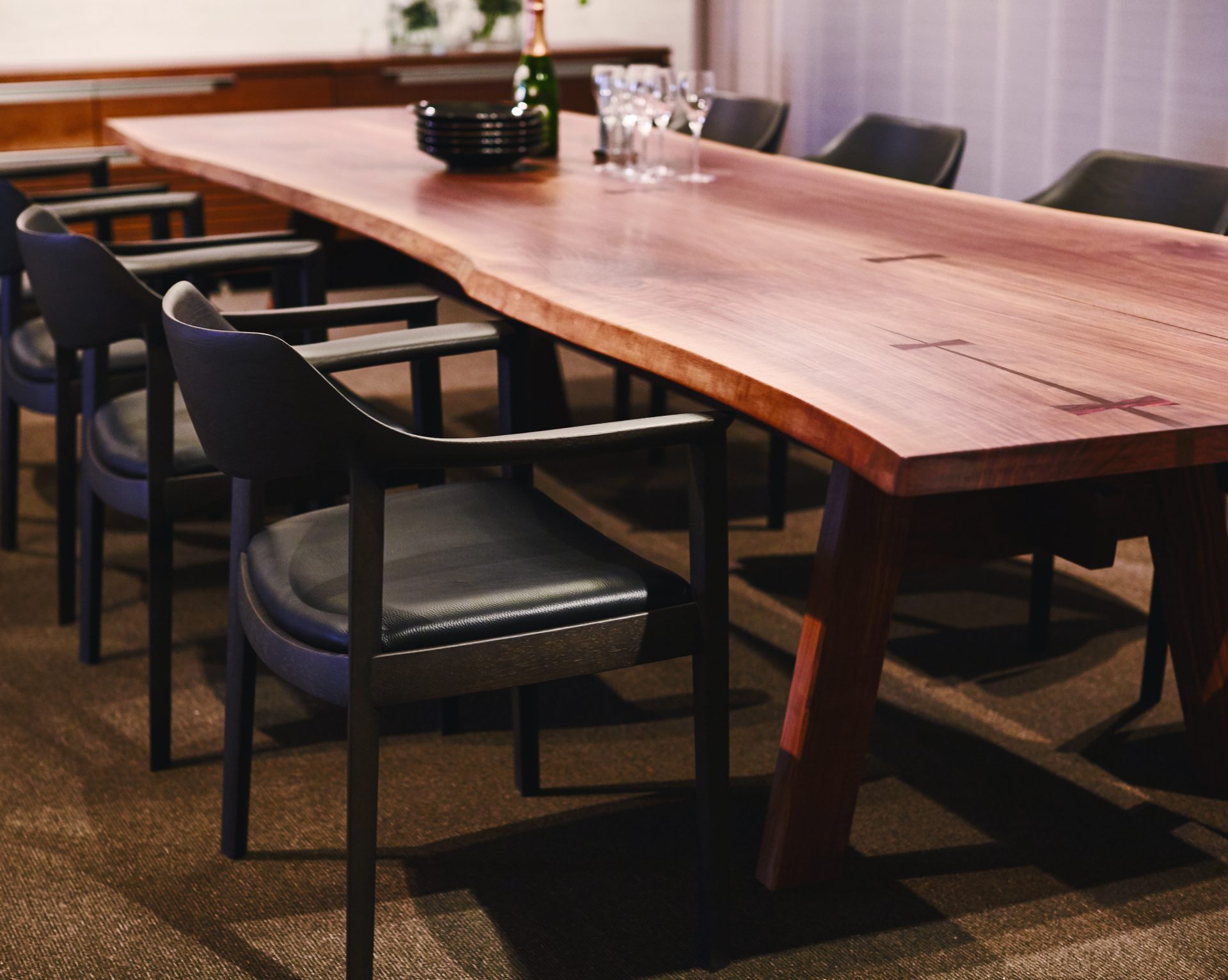 The table displayed in our headquarters shop. It's a long one, like more than 3 meters, set with four chairs on one side.