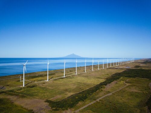 Wind power generators aligned along the coast