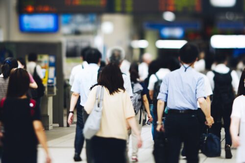 A station with many people commuting to the office in the morning