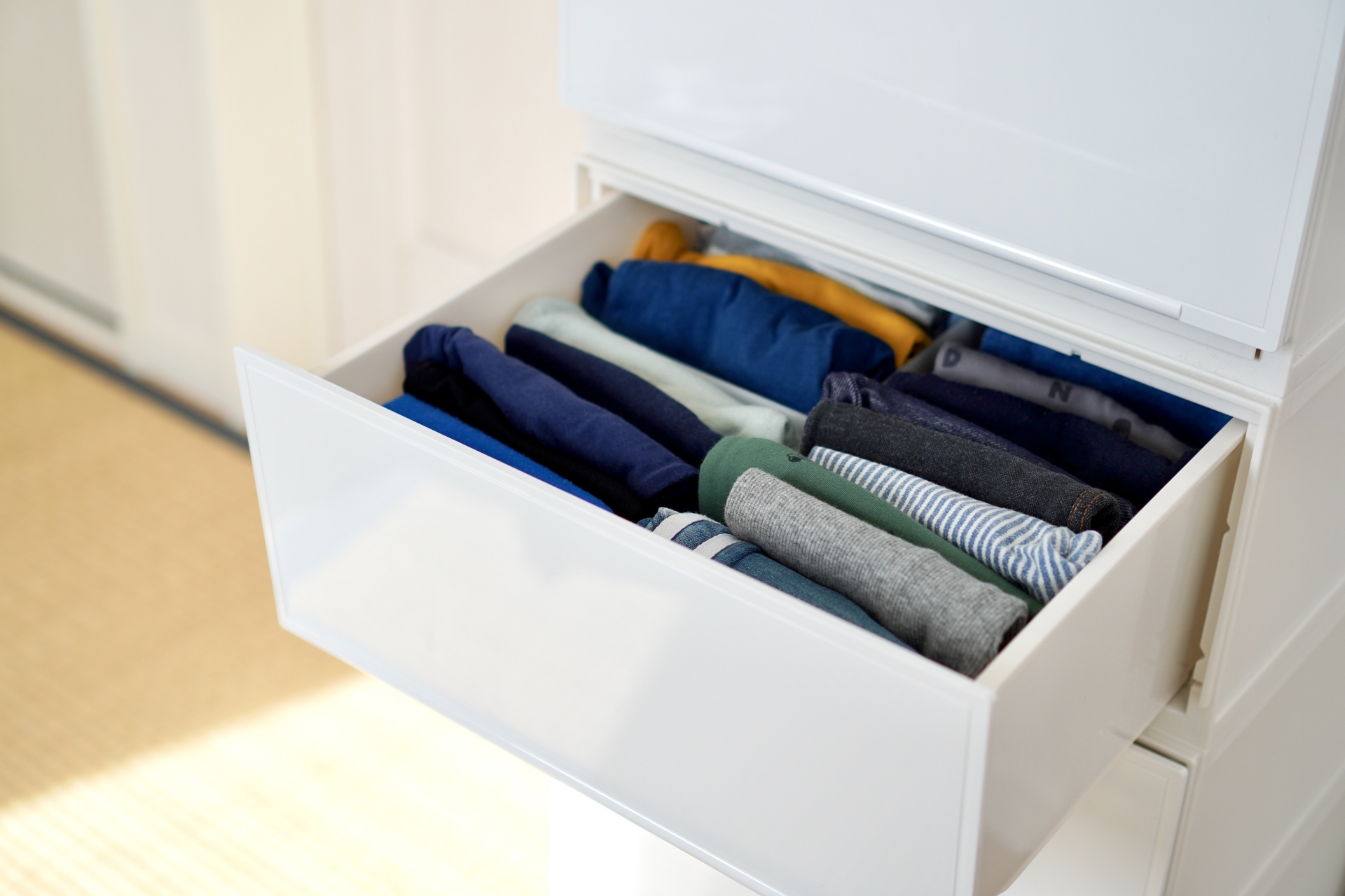 Folded clothes in the drawer of a cabinet