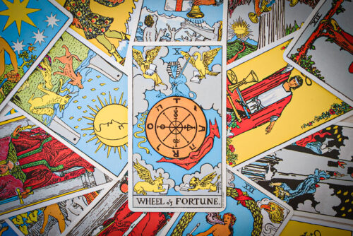 Tarot cards, on top of which there's a card of Wheel of Fortune