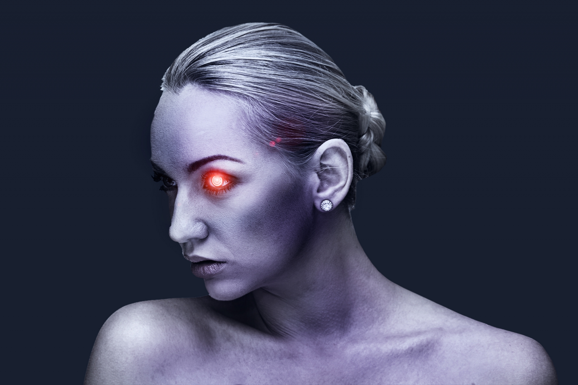 A woman with one of her eyes emitting a red light