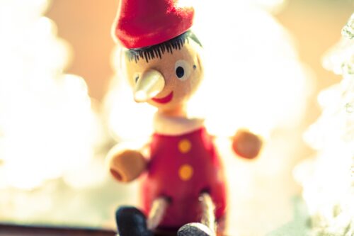 A wooden Pinocchio doll in red cloths