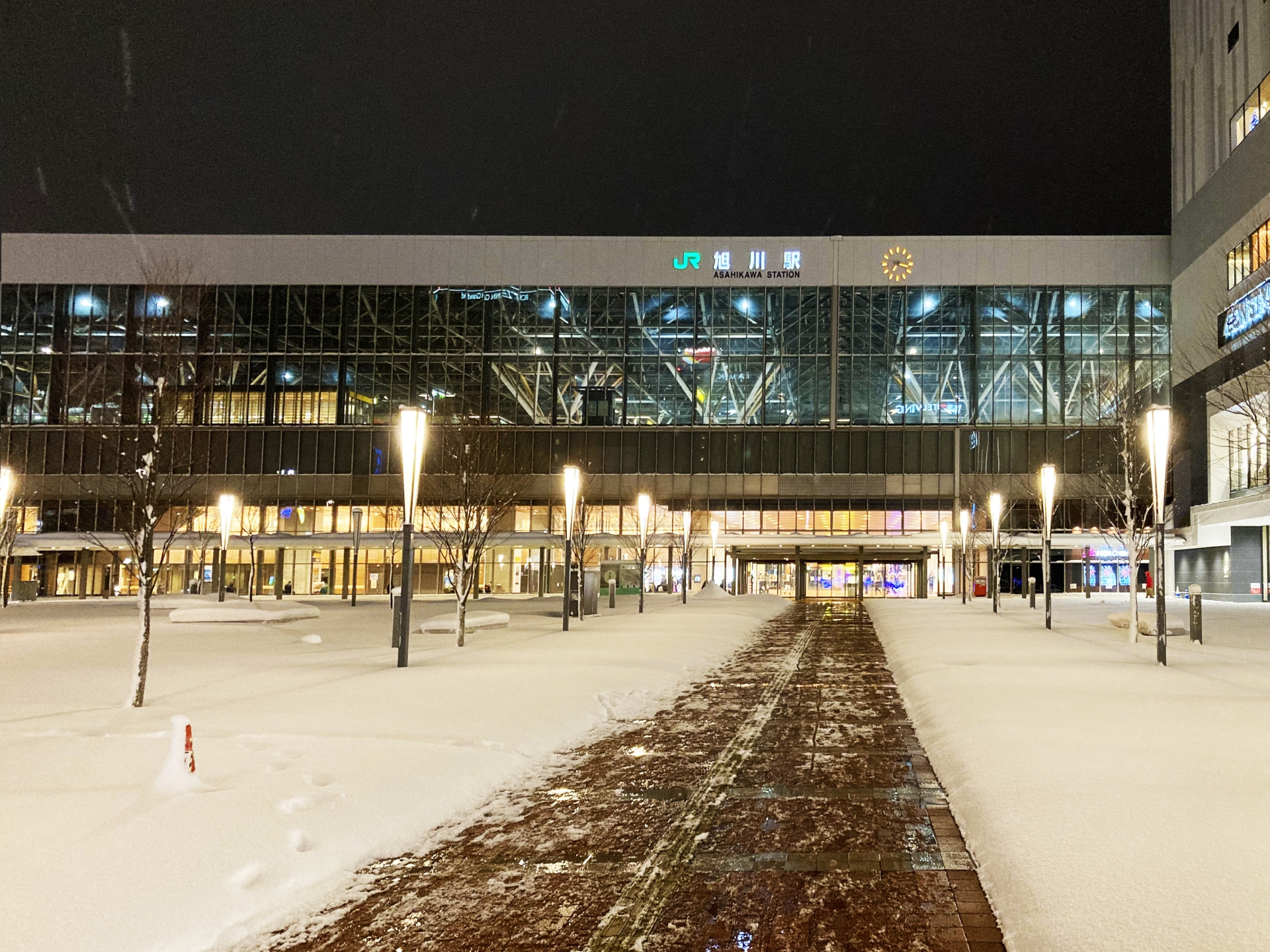 Asahikawa central station in winter, of which front yard is covered with snow
