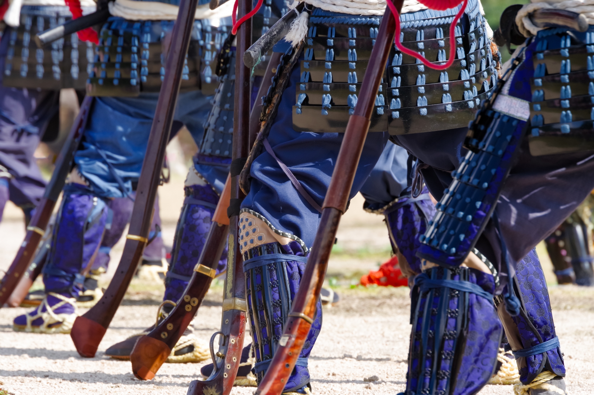 Some samurai warriors are lined up with rifles.