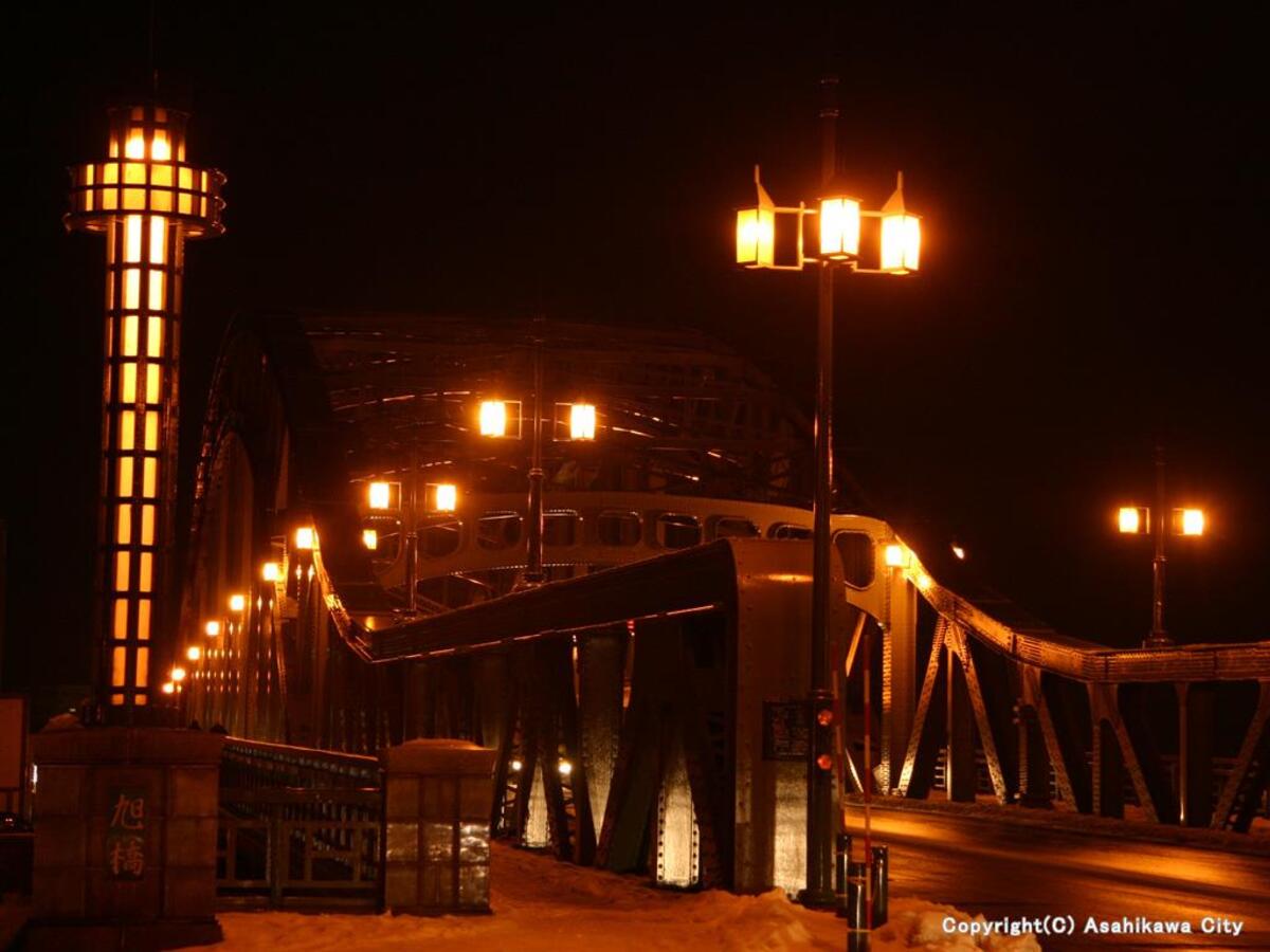 Asahibashi bridge with orange-tinted lighting of street lamps at night