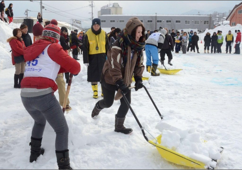 A competition where people shovel and move snow with a snow-scoop