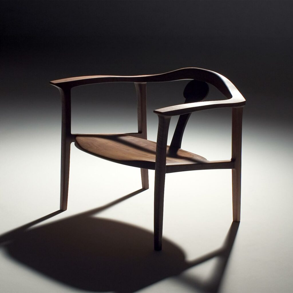 A living-roon chair made of walnut, designed by Masayuki Nagare, a Japanese carver. It looks like a sculpture rahter than a chair.