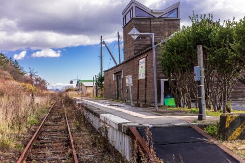 A closed station somewhere in Hokkaido, and rusty rails extending into the distance