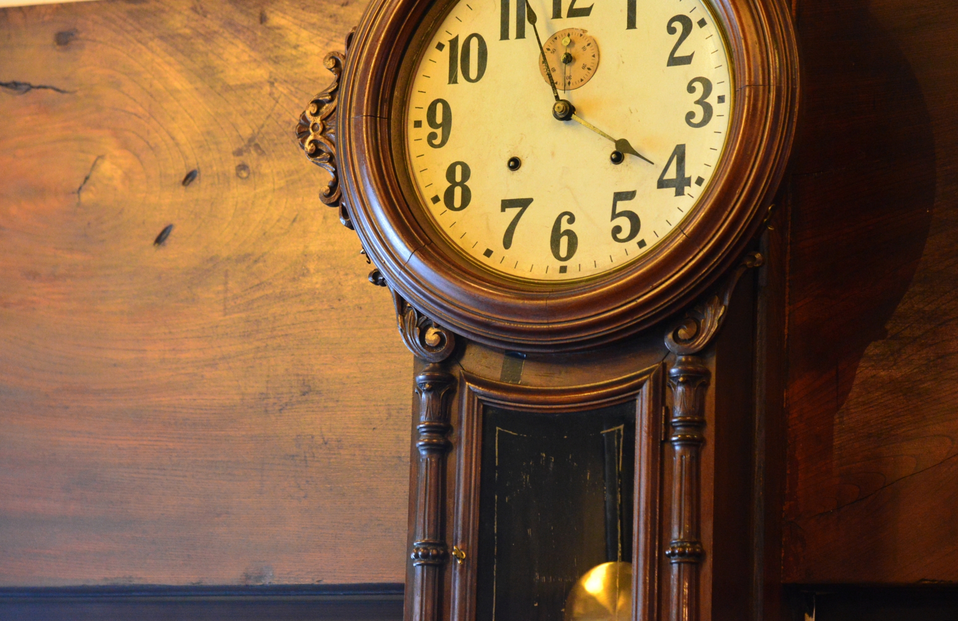 An old wall clock pointing to about 4 o'clock