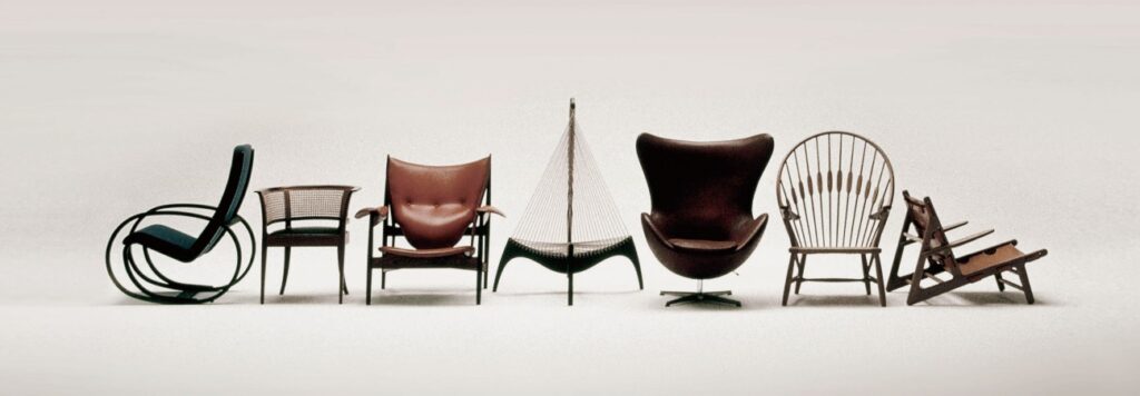 Seven historic chairs are lined up. They are a part of the world's largest chair collection.