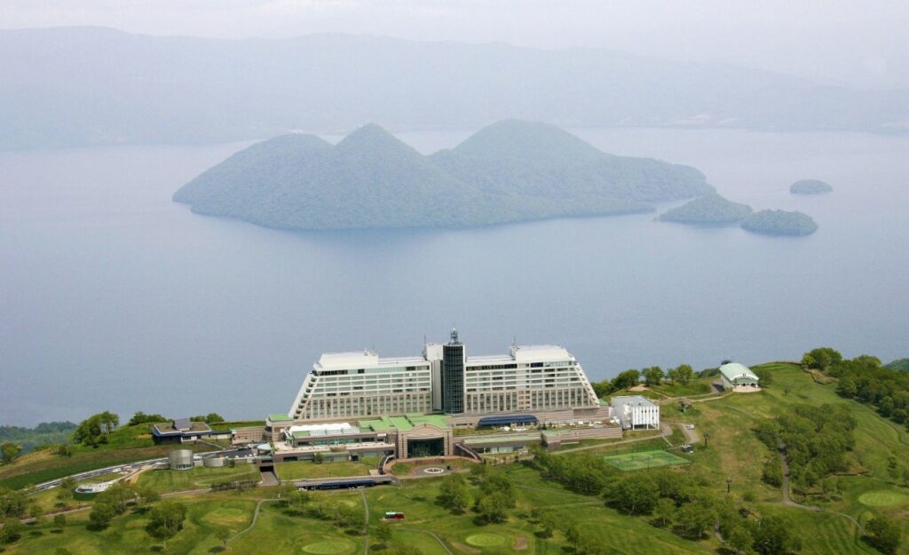 Toya lake behind The Windsor Hotel on the top of the hill