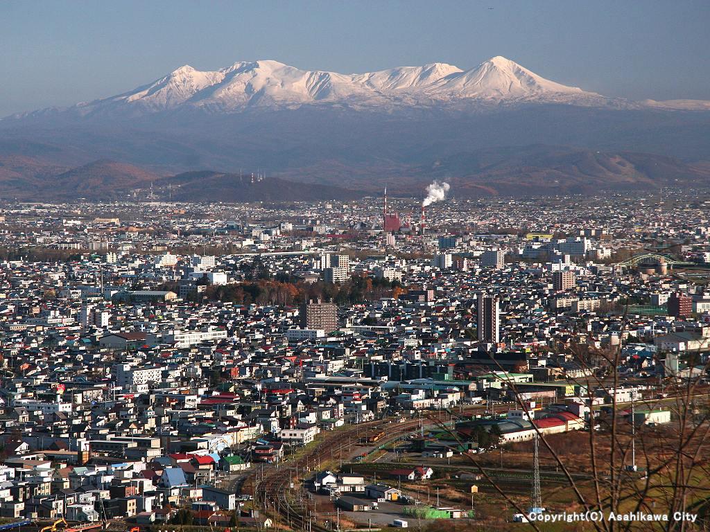 Asahikawa city with Taisetsu-zan, the Hokkaido-highest mountains in the back