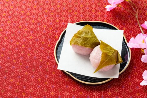 Sakura-mochi, mochi wrapped in a salted leaf of Sakura (cherry tree) on a black plate