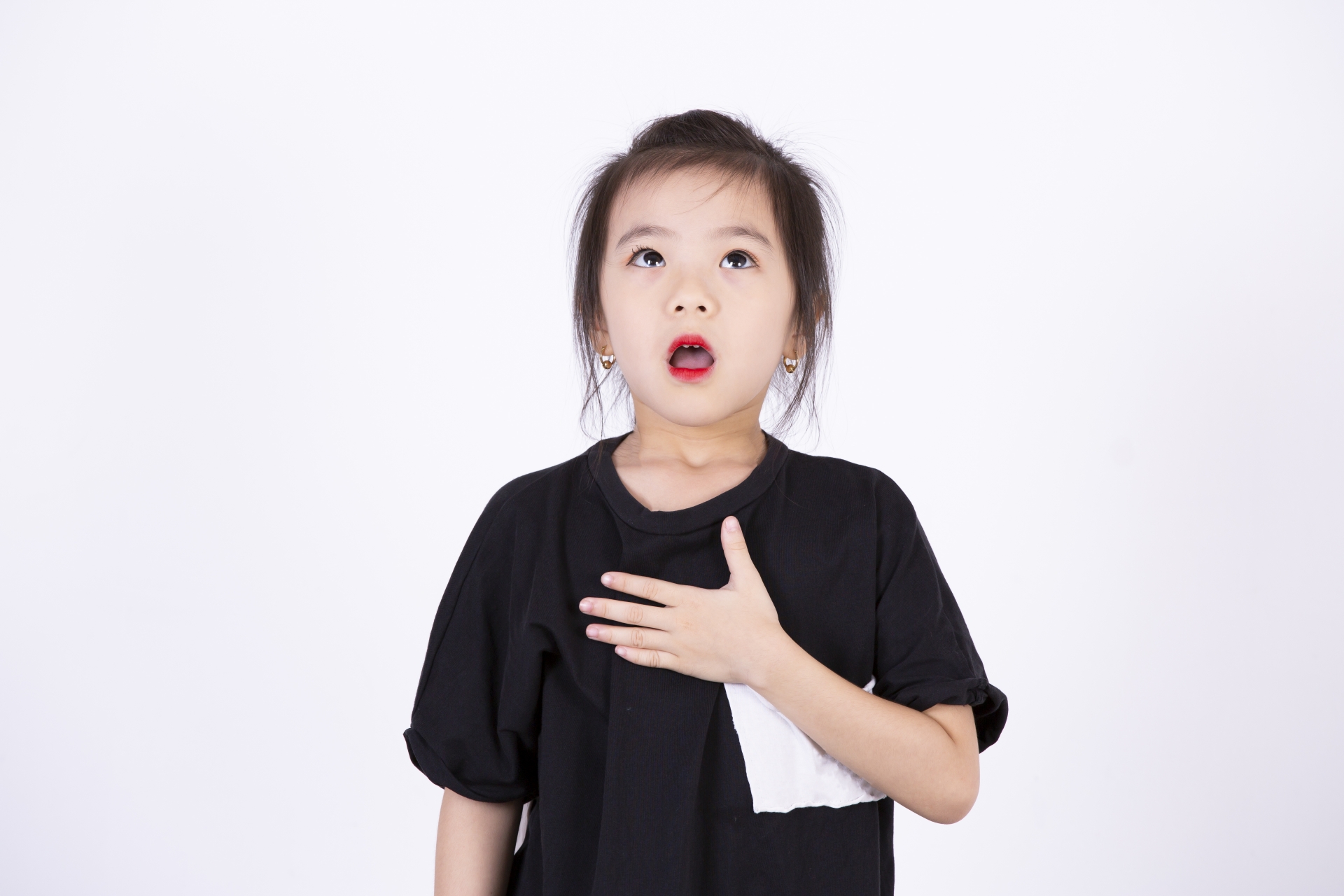 A girl in a black T-shirt practicing singing